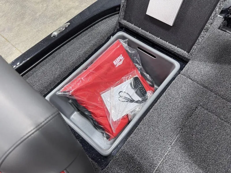 Slide: The Image of Storage compartment in 2025 Nitro Z18 Pro boat with red life jacket. - 18