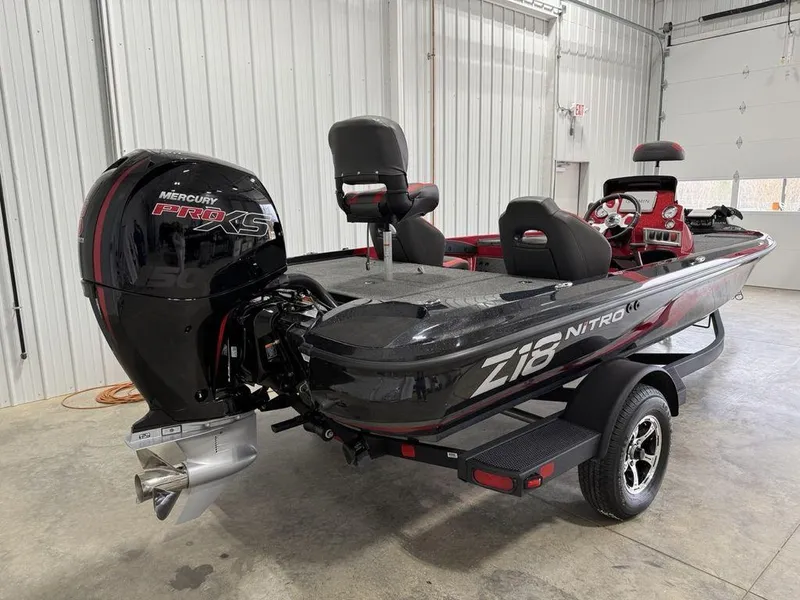 Slide: The Image of 2025 Nitro Z18 Pro boat with Mercury engine in a garage setting. - 2