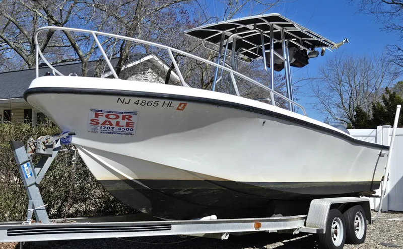 The Image of 1994 Mako 231 boat on trailer, for sale sign, parked outdoors. - 0