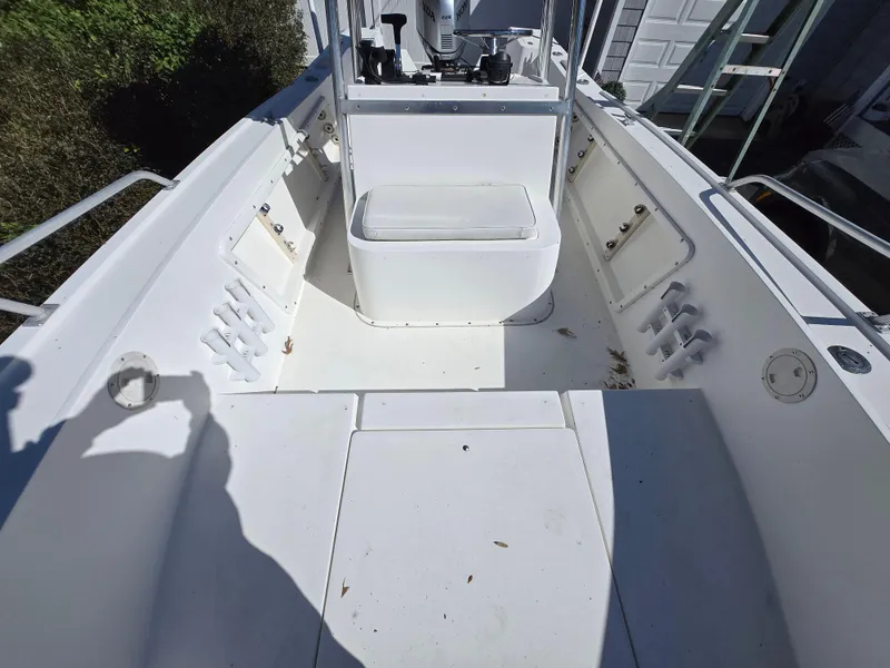 Slide: The Image of 1994 Mako 231 boat interior, featuring spacious deck and seating area. - 10