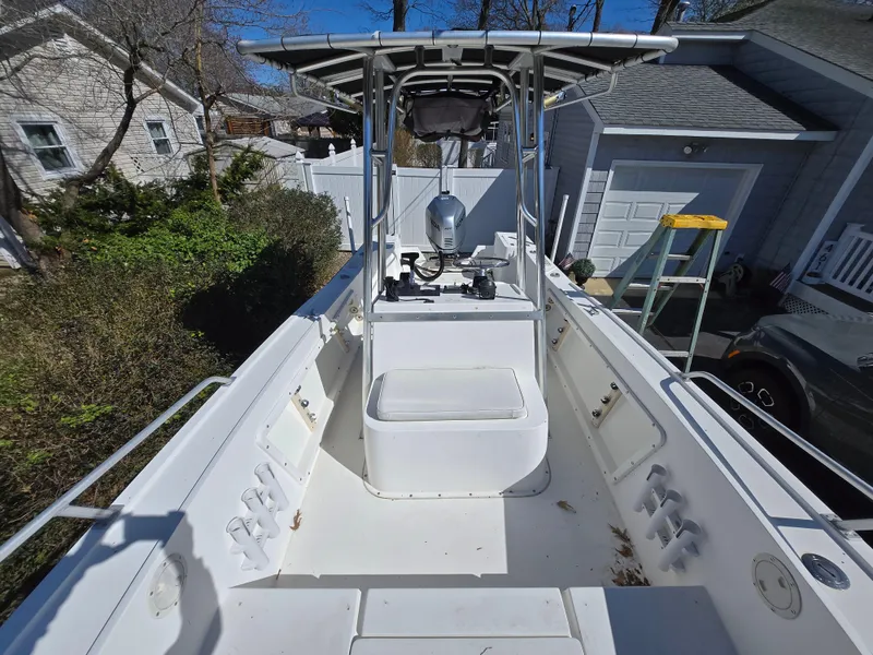 Slide: The Image of 1994 Mako 231 boat with center console, parked in a residential driveway. - 11