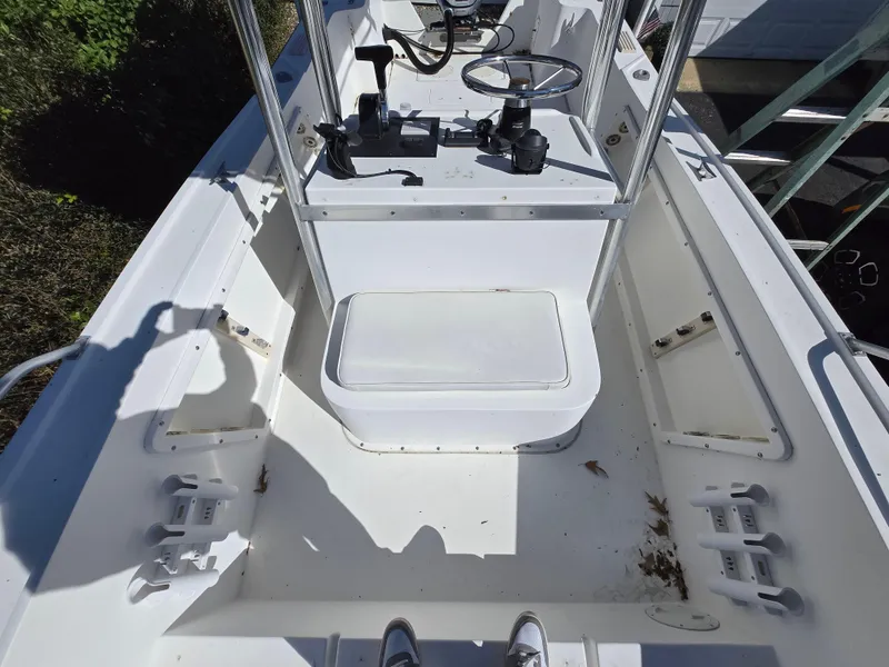 Slide: The Image of 1994 Mako 231 boat interior with steering console and seating area. - 12