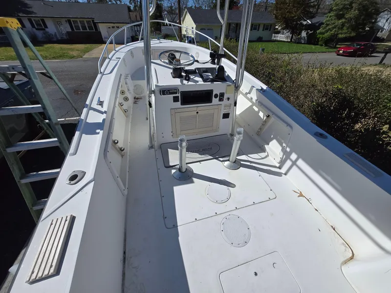 Slide: The Image of 1994 Mako 231 boat interior with steering console and seating area. - 2