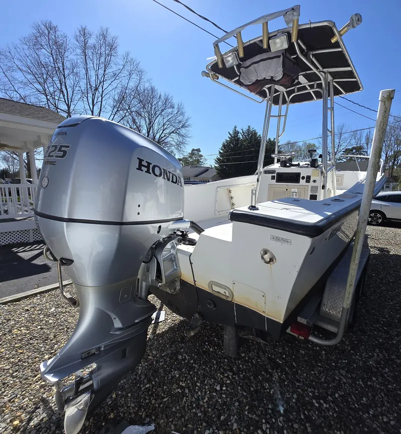 Slide: The Image of 1994 Mako 231 boat with Honda 225 outboard motor, parked on gravel driveway. - 23