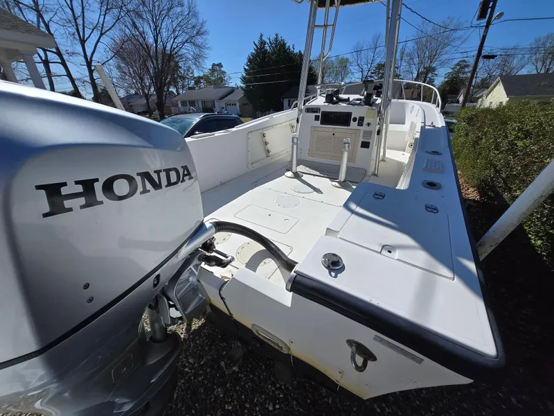 Slide: The Image of 1994 Mako 231 boat with Honda outboard motor, parked outdoors. - 26