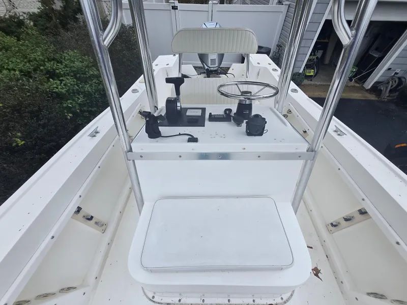 Slide: The Image of 1994 Mako 231 boat interior with steering console and seating. - 28