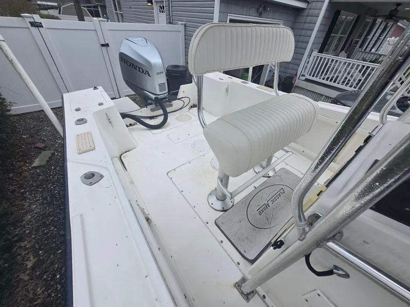 Slide: The Image of 1994 Mako 231 boat with Honda outboard motor and white seating. - 3