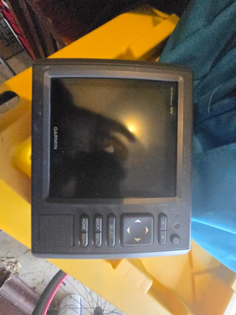 Slide: The Image of Garmin marine GPS device on a yellow surface, Mako 231, 1994 model. - 31