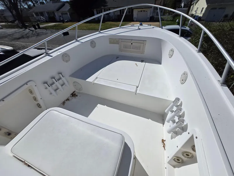 Slide: The Image of 1994 Mako 231 boat deck with seating and storage compartments. - 5
