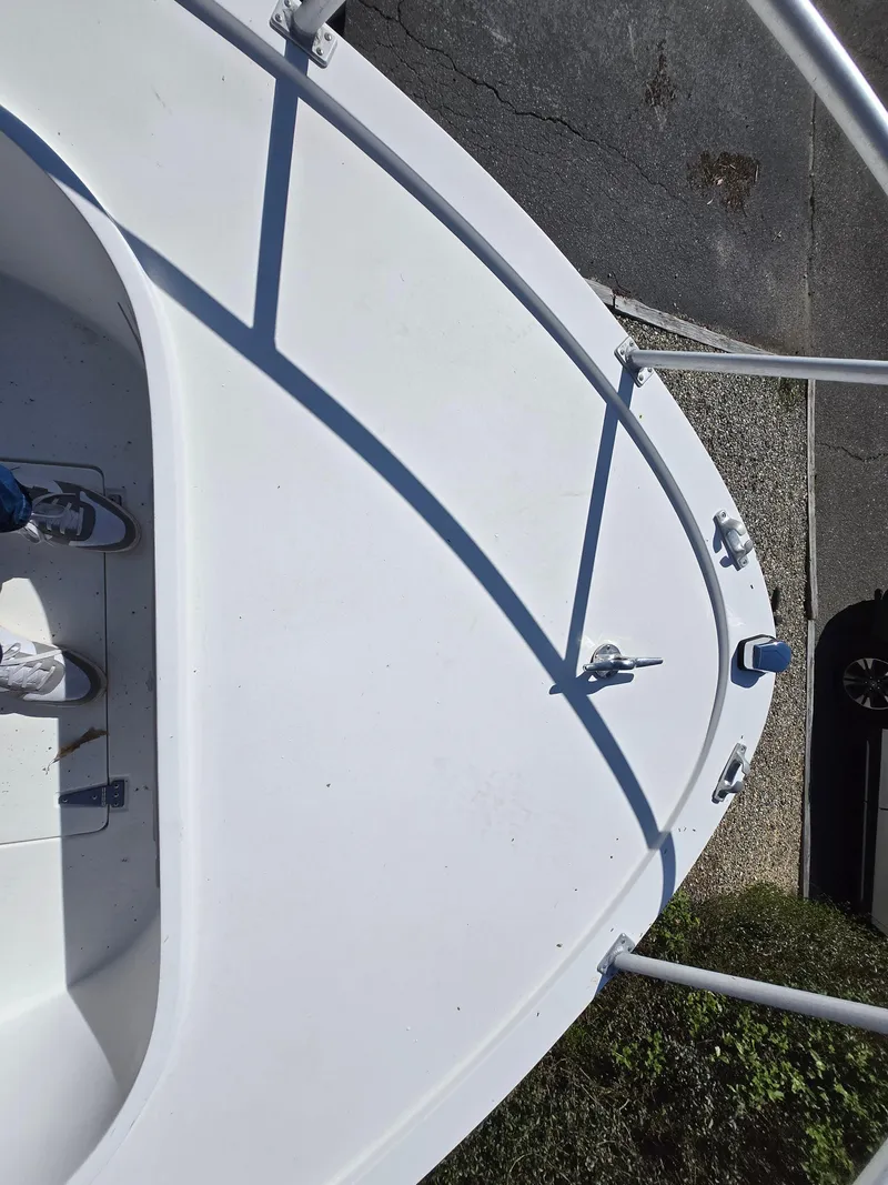 Slide: The Image of 1994 Mako 231 boat deck with railings and cleats, viewed from above. - 9