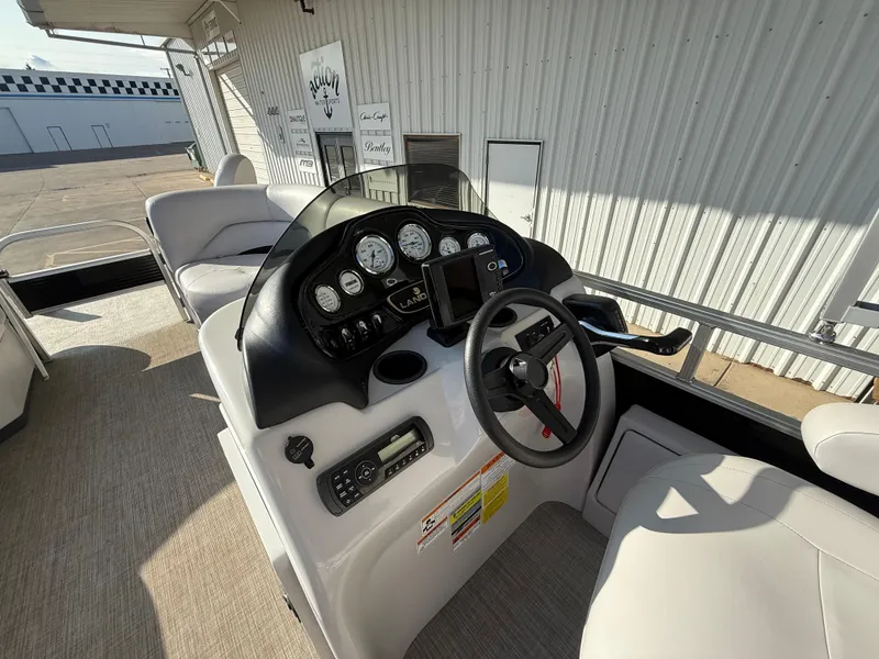 Slide: The Image of 2018 Landau Island Breeze 212C boat dashboard with steering wheel and gauges. - 11