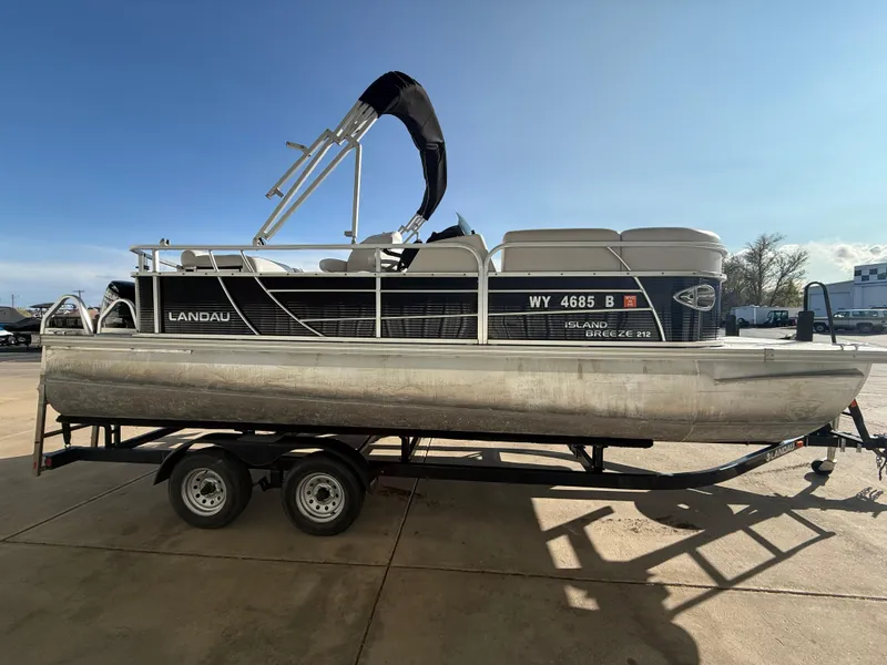 Slide: The Image of 2018 Landau Island Breeze 212C pontoon boat on trailer, side view, sunny day. - 4