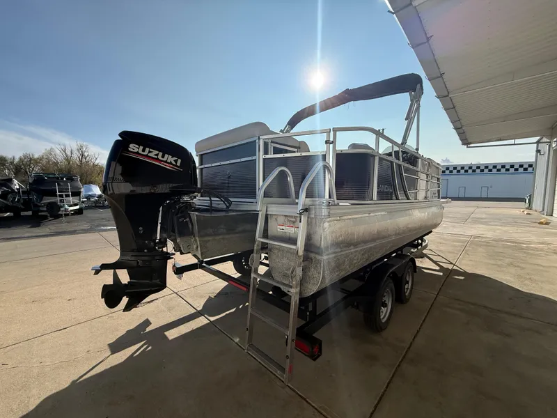 Slide: The Image of 2018 Landau Island Breeze 212C pontoon boat with Suzuki outboard motor in a sunny outdoor setting. - 5