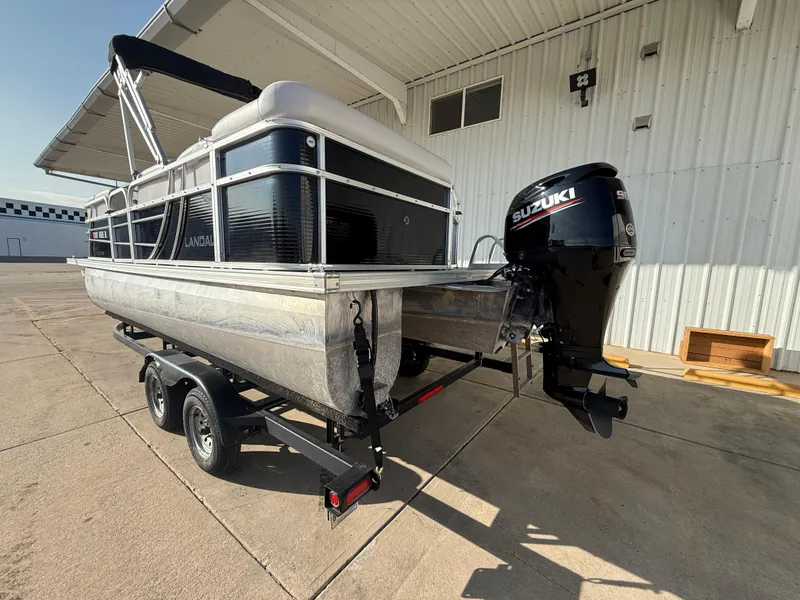 Slide: The Image of 2018 Landau Island Breeze 212C pontoon boat with Suzuki outboard motor on trailer. - 6