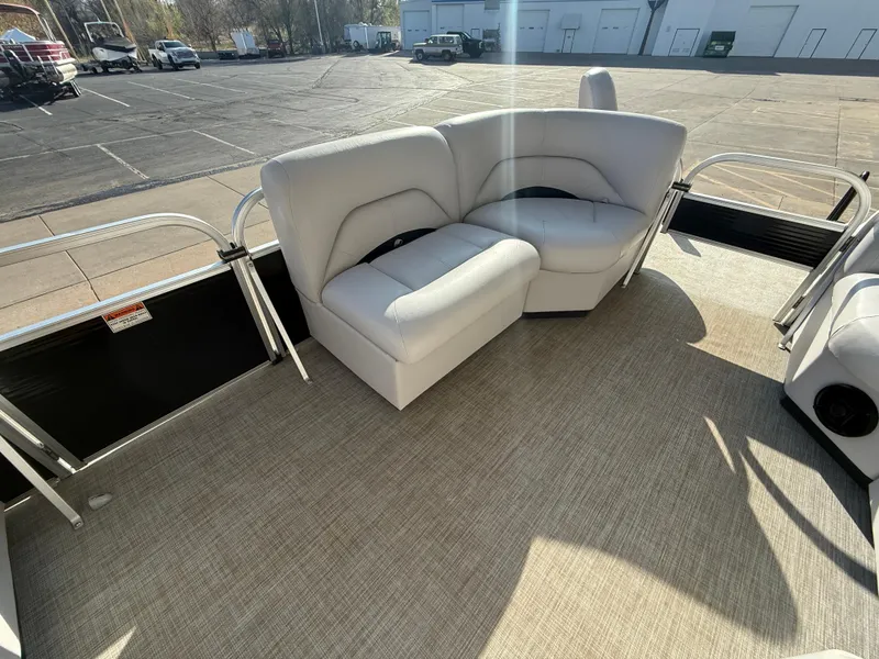 Slide: The Image of 2018 Landau Island Breeze 212C pontoon boat with beige seating and carpeted deck. - 8