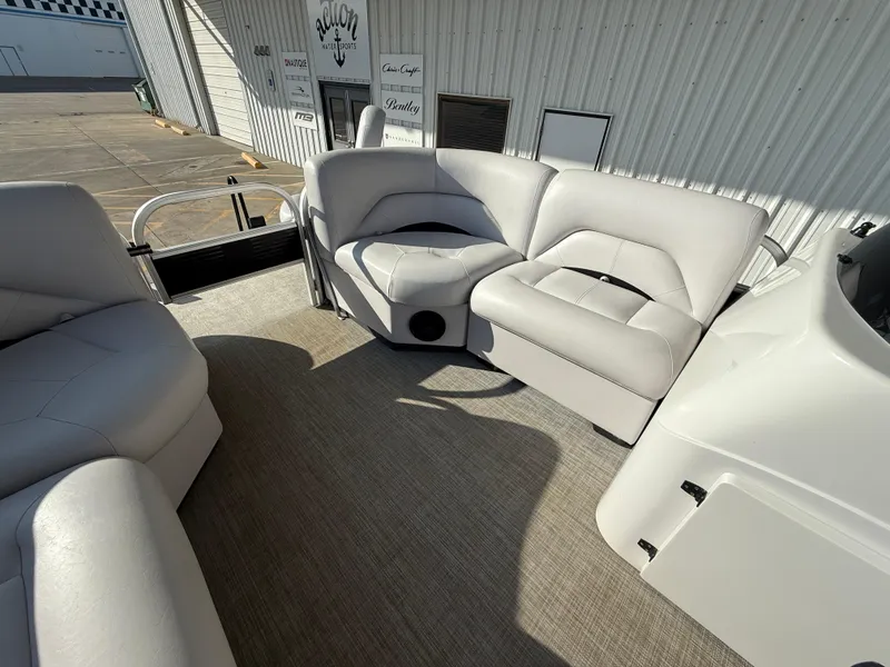 Slide: The Image of 2018 Landau Island Breeze 212C pontoon boat interior with plush seating and carpeted floor. - 9