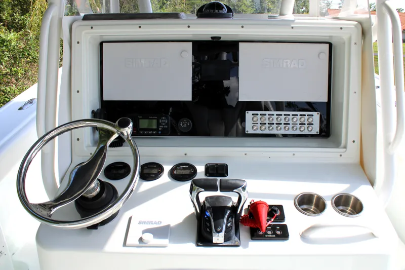 Slide: The Image of 2007 Yellowfin 36 Offshore boat dashboard with steering wheel and control panel. - 16