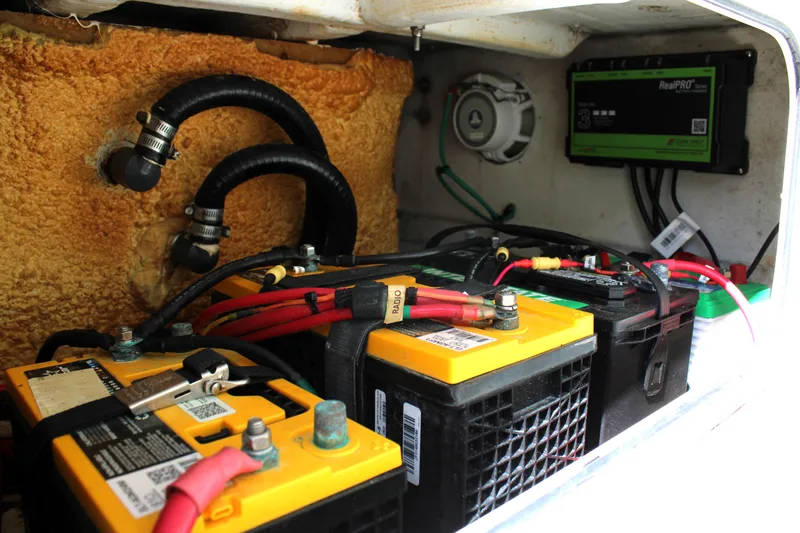 Slide: The Image of Battery compartment of a 2007 Yellowfin 36 Offshore boat with wiring and components. - 23