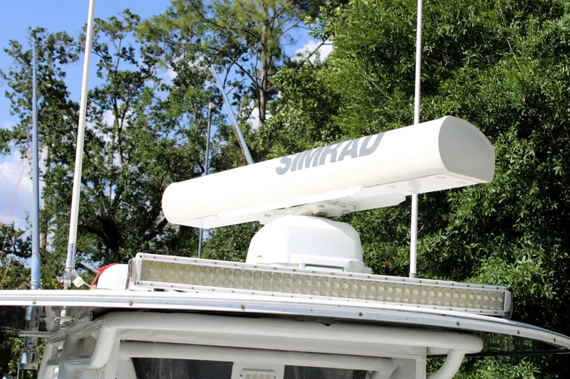 Slide: The Image of 2007 Yellowfin 36 Offshore boat with Simrad radar, surrounded by trees. - 35