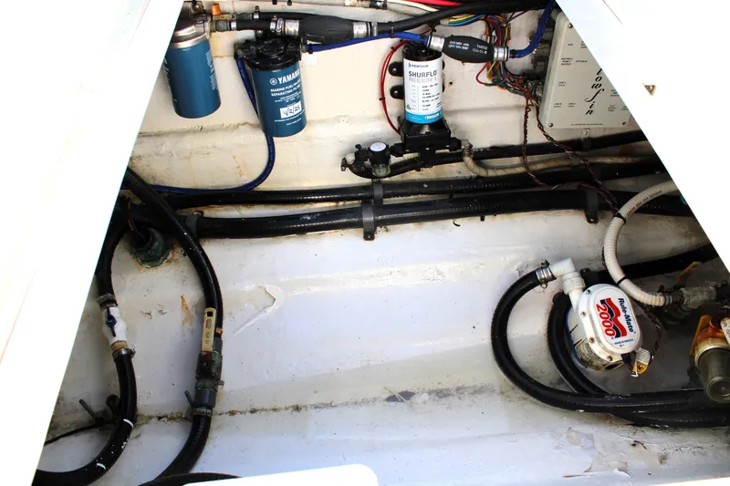 Slide: The Image of 2007 Yellowfin 36 Offshore engine compartment with filters and wiring. - 36