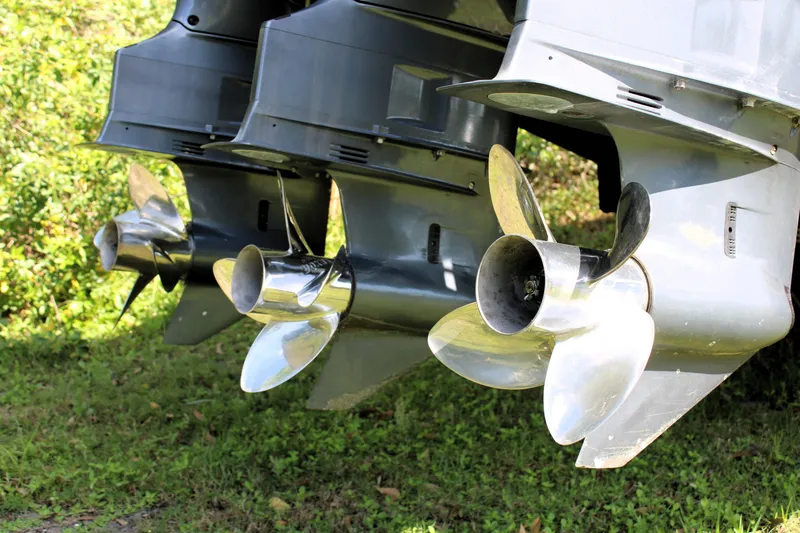 Slide: The Image of Triple outboard motors on a 2007 Yellowfin 36 Offshore boat, displayed on grass. - 6
