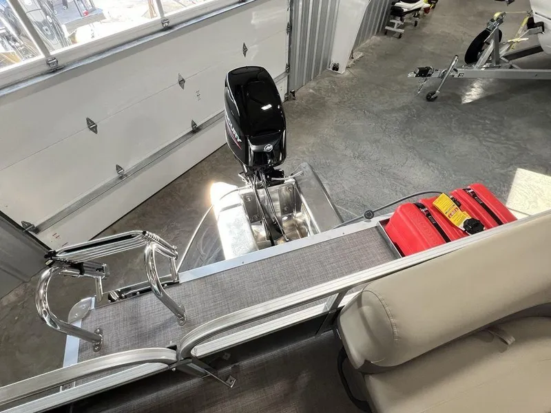 Slide: The Image of 2025 Sun Tracker PARTY BARGE® 16 DLX pontoon boat interior with motor and seating. - 15
