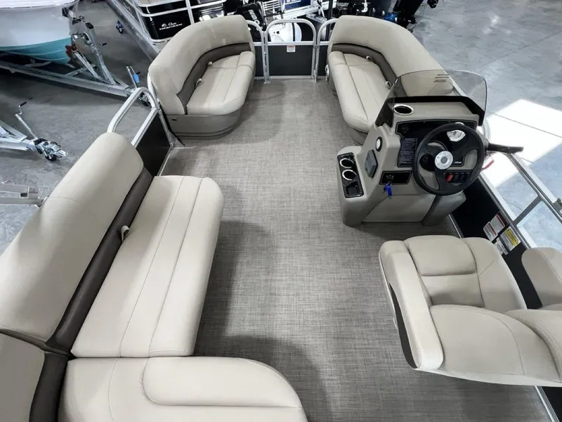 Slide: The Image of 2025 Sun Tracker PARTY BARGE® 16 DLX interior with spacious seating and modern helm. - 16