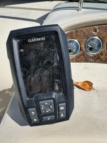 Slide: The Image of Garmin device on 2002 Sea Ray 260 Sundancer dashboard with gauges. - 12