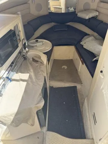 Slide: The Image of Interior of 2002 Sea Ray 260 Sundancer boat with seating and kitchenette. - 13