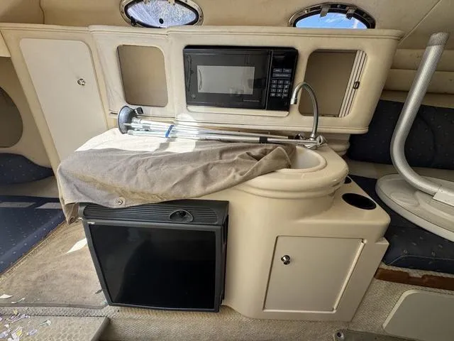 Slide: The Image of Interior of a 2002 Sea Ray 260 Sundancer with kitchenette and appliances. - 17