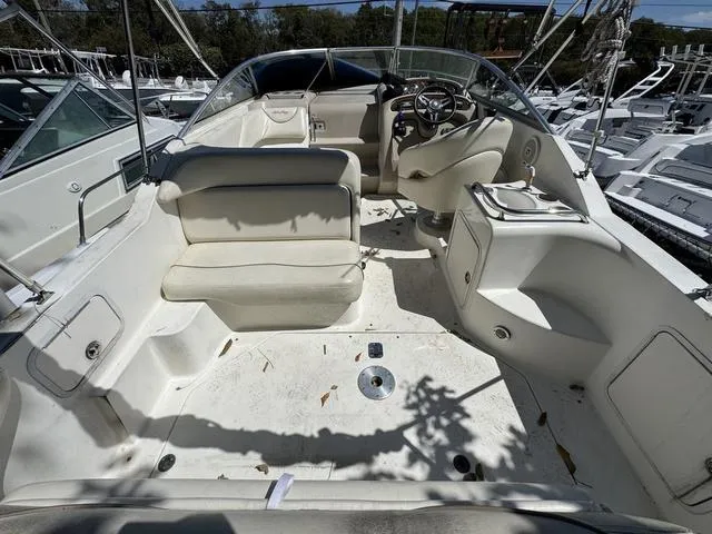 Slide: The Image of 2002 Sea Ray 260 Sundancer boat interior with seating and steering wheel. - 4