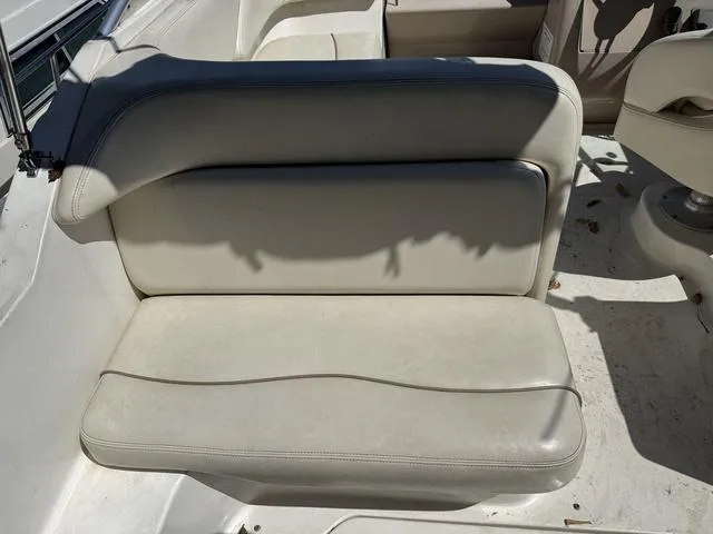 Slide: The Image of 2002 Sea Ray 260 Sundancer boat seat, white upholstery, outdoor setting. - 6