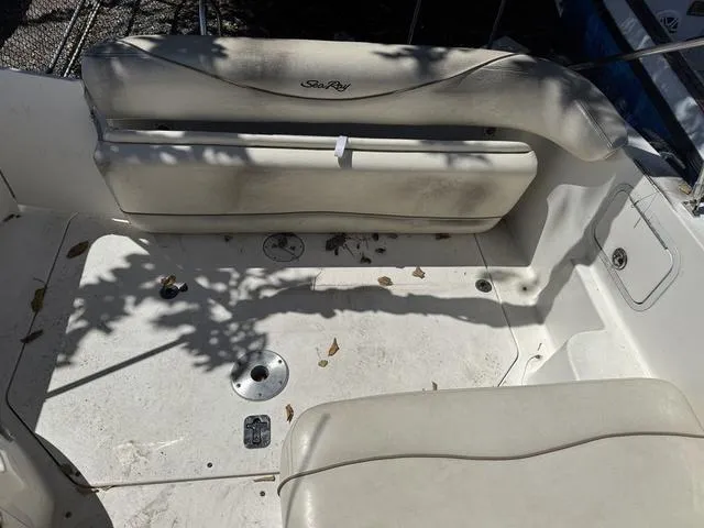 Slide: The Image of 2002 Sea Ray 260 Sundancer boat interior with white seating and deck. - 7