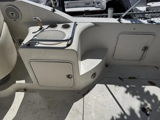 Slide: The Image of 2002 Sea Ray 260 Sundancer boat interior with sink and storage compartments. - 8