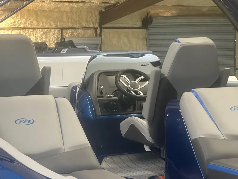 Slide: The Image of 2024 Manitou XT RFXW boat interior with modern steering and seating. - 3