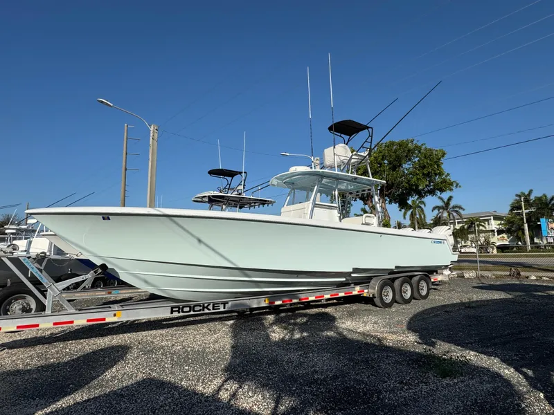 Slide: The Image of 2024 Contender 39 ST boat on trailer under clear blue sky. - 0