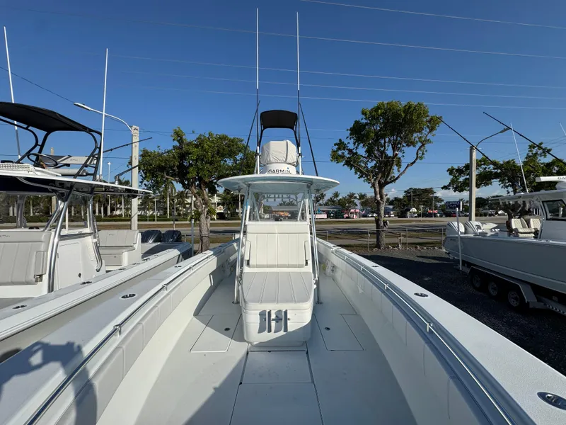Slide: The Image of 2024 Contender 39 ST boat, sleek design, docked outdoors under clear blue sky. - 10