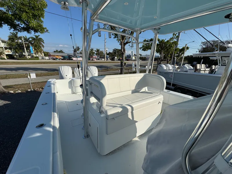 Slide: The Image of 2024 Contender 39 ST boat with spacious seating and sleek design, docked outdoors. - 12