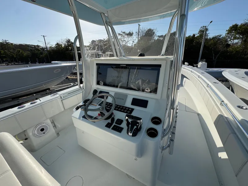 Slide: The Image of 2024 Contender 39 ST boat cockpit with modern controls and steering wheel. - 14