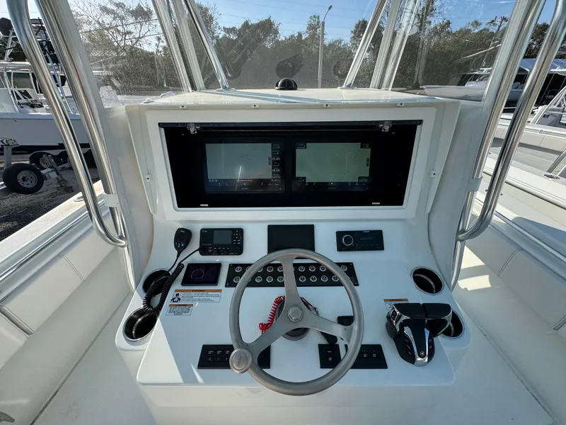 Slide: The Image of 2024 Contender 39 ST boat console with dual screens and steering wheel. - 15