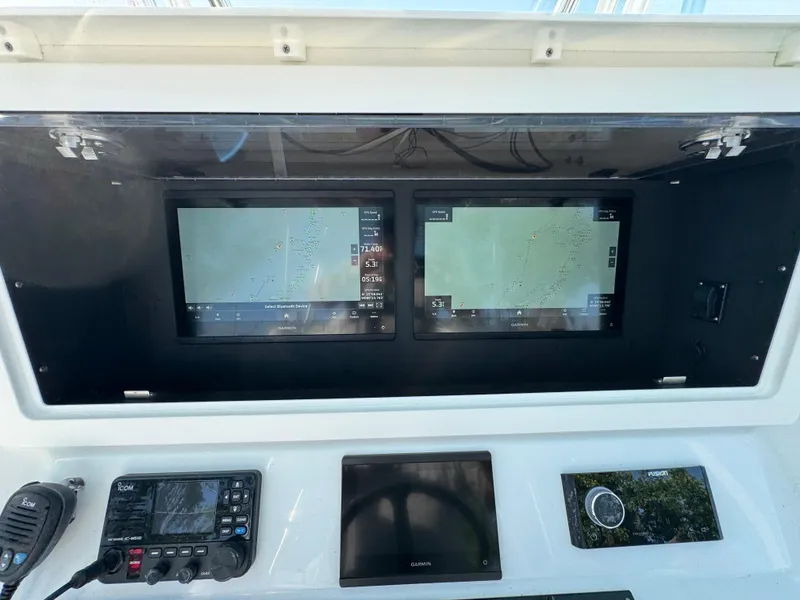 Slide: The Image of 2024 Contender 39 ST boat dashboard with dual navigation screens and control panel. - 17