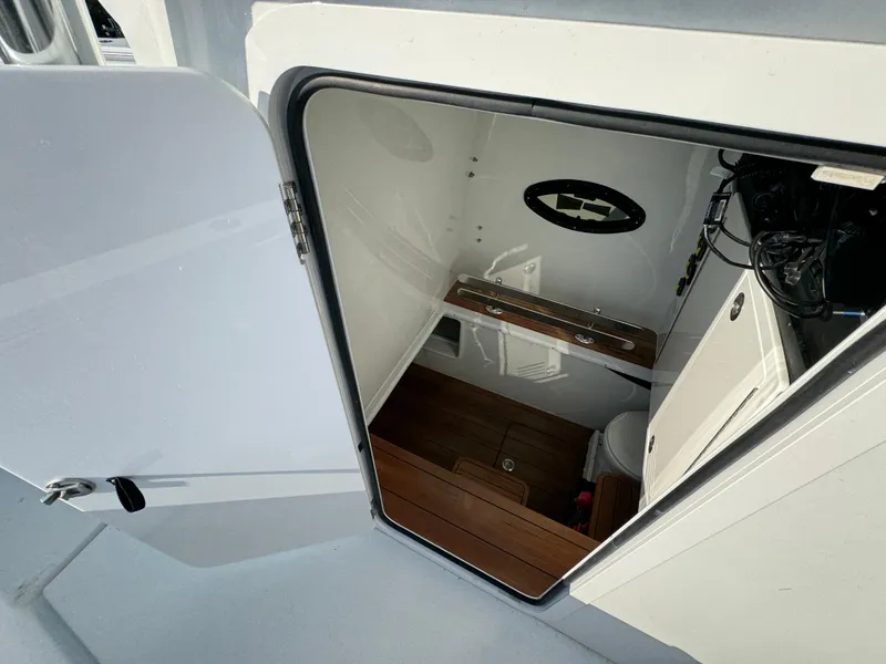 Slide: The Image of 2024 Contender 39 ST boat interior cabin with wooden flooring and compact amenities. - 28