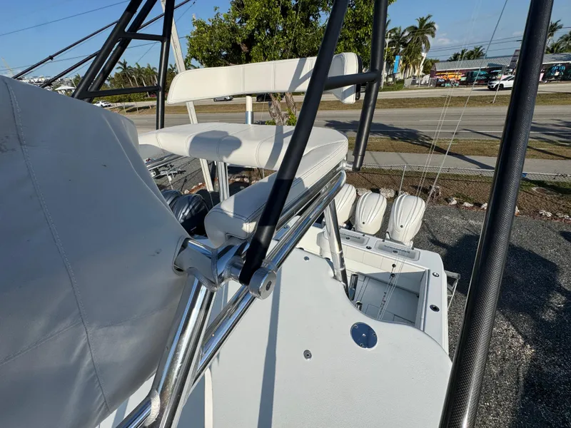 Slide: The Image of 2024 Contender 39 ST boat with white seating and metal framework, docked outdoors. - 32