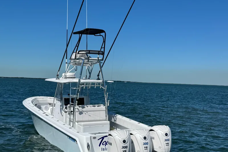 Slide: The Image of 2024 Contender 39 ST boat with triple 300 V6 engines on open water. - 5