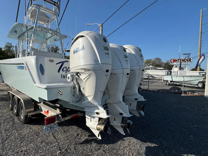 Slide: The Image of 2024 Contender 39 ST boat with triple Yamaha outboard engines on a trailer. - 6