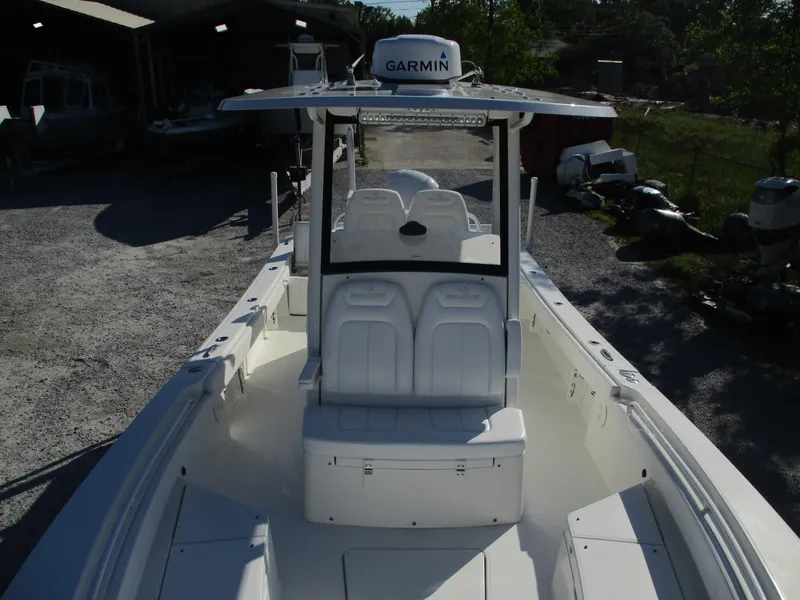 Slide: The Image of 2020 Regulator 26XO boat with Garmin equipment, docked outdoors. - 15