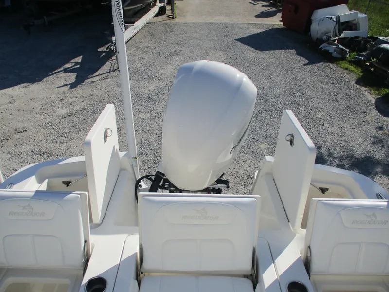 Slide: The Image of 2020 Regulator 26XO boat with outboard motor, rear view on gravel surface. - 6
