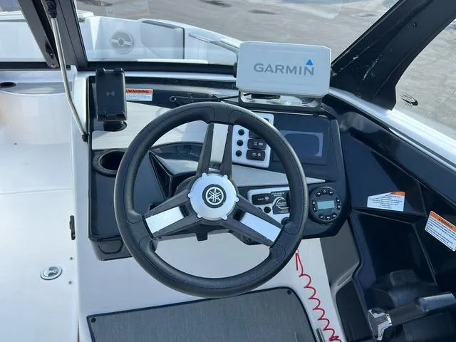 Slide: The Image of 2024 Yamaha SX220 boat dashboard with Garmin navigation system and steering wheel. - 5