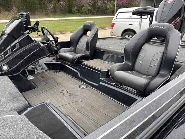 Slide: The Image of 2024 Nitro Z21 XL Pro boat interior with sleek black seating and modern dashboard design. - 10