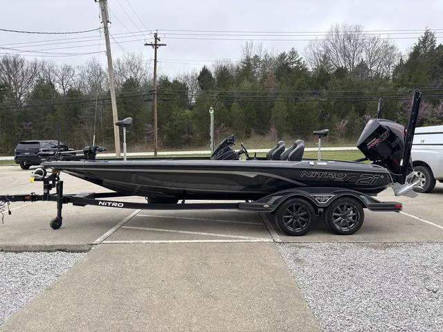 Slide: The Image of 2024 Nitro Z21 XL Pro bass boat on trailer, parked outdoors. - 13
